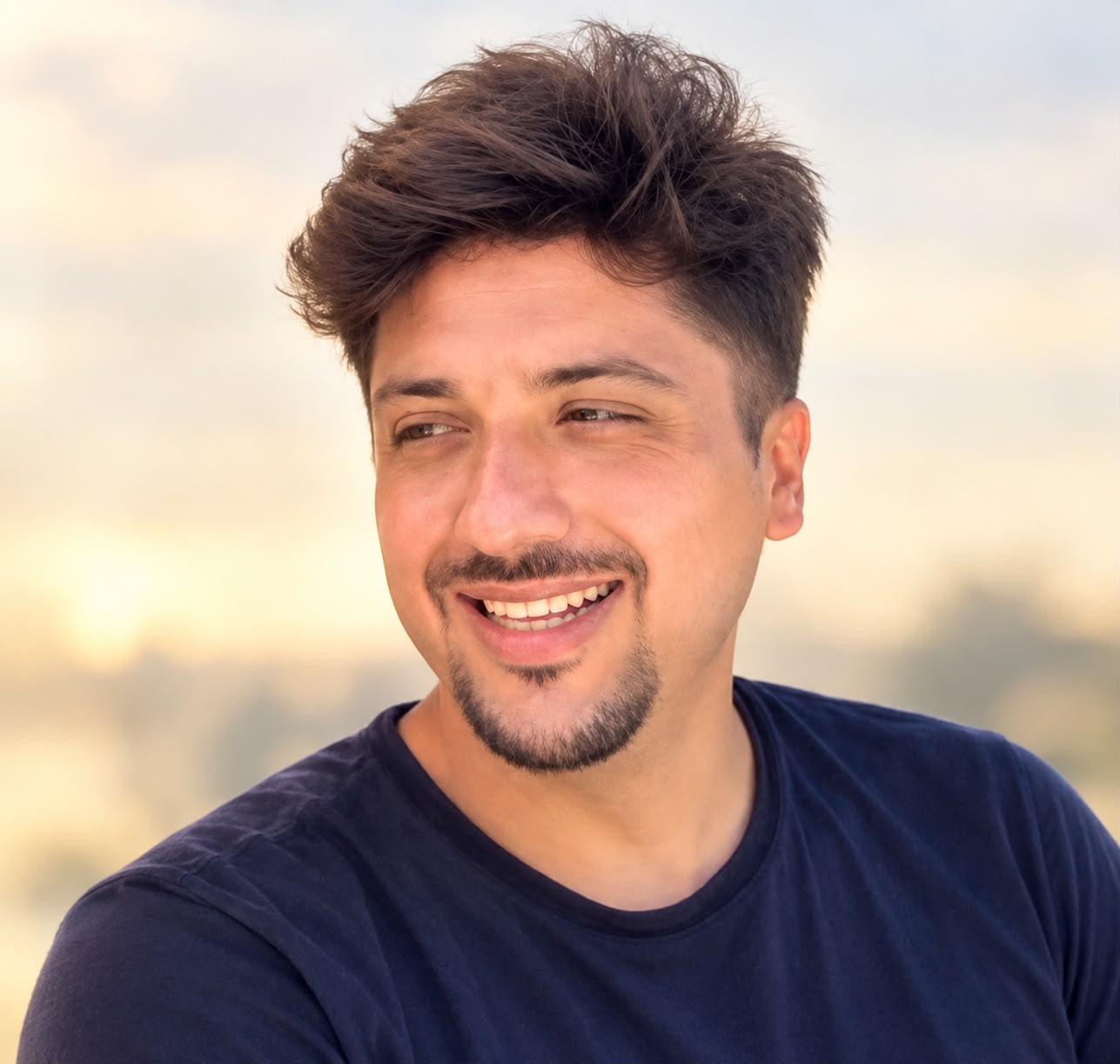 Carlos Eduardo Ibarra López smiling, wearing a dark blue T-shirt